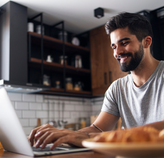 Guy smiling using laptop