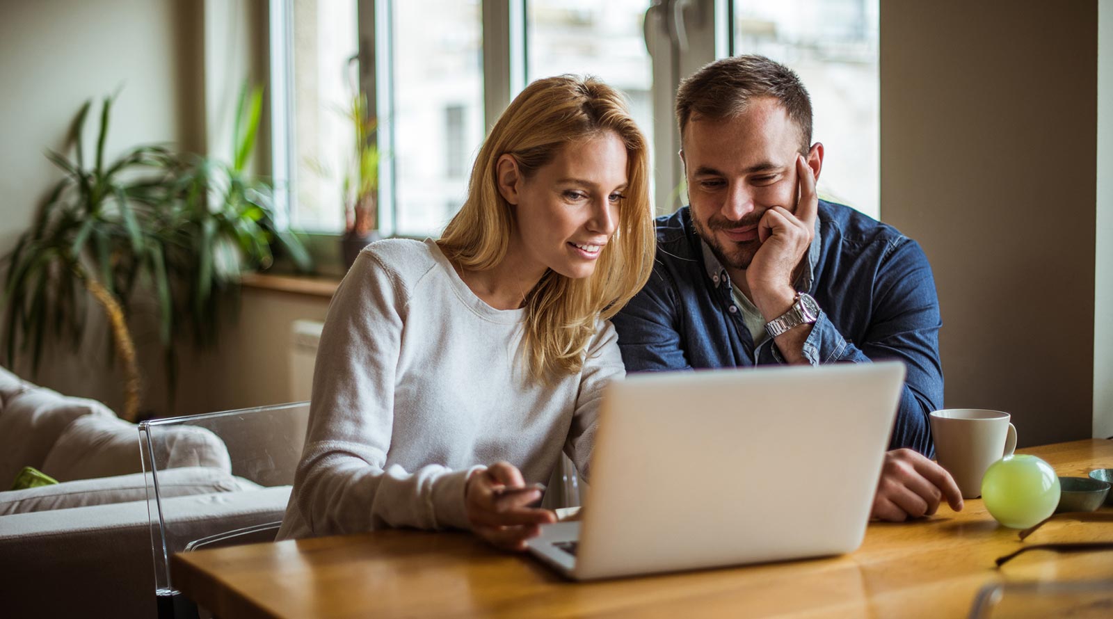 Two people using a laptop