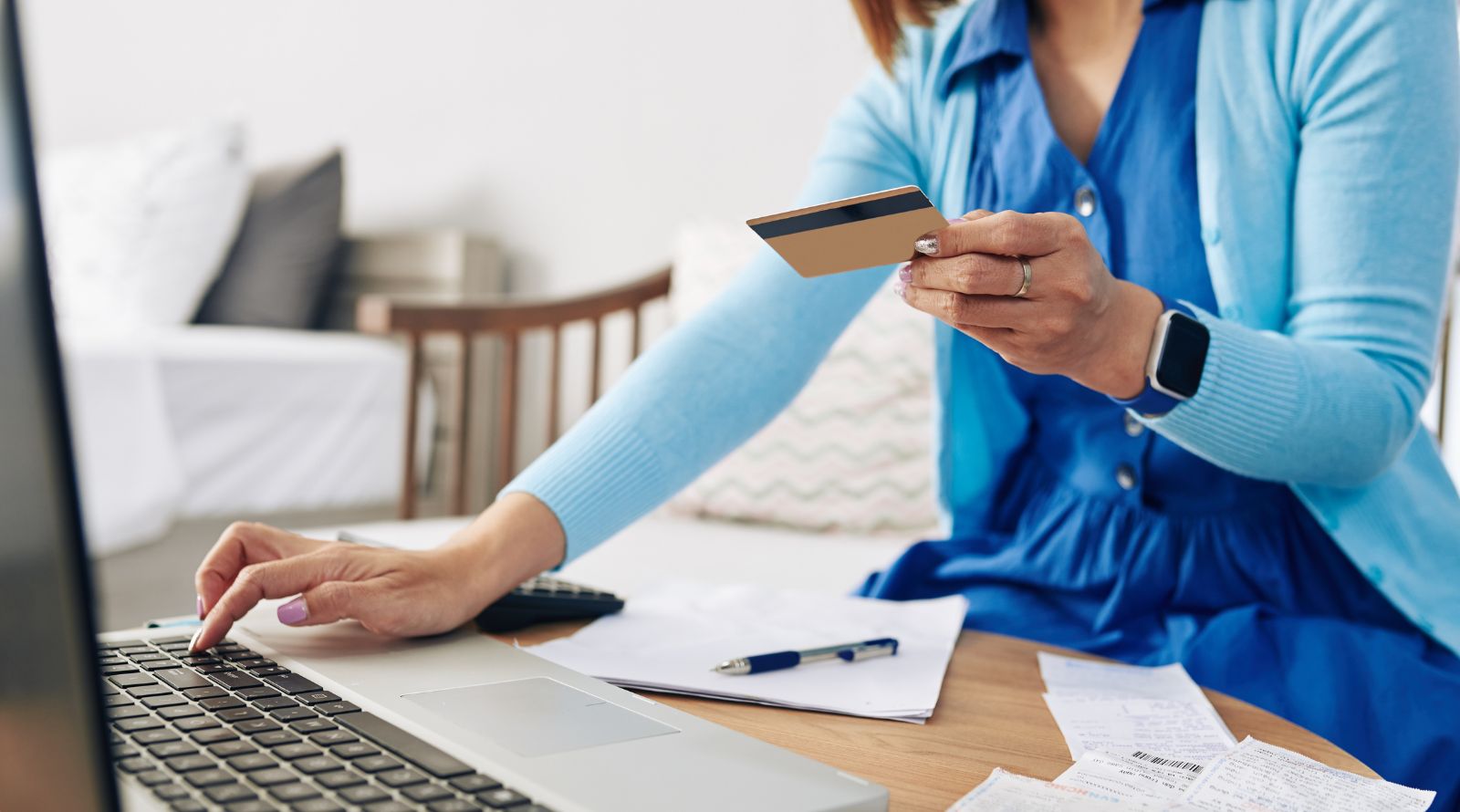 Girl in blue sweater using debit card