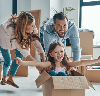 Family with kid in a box having fun