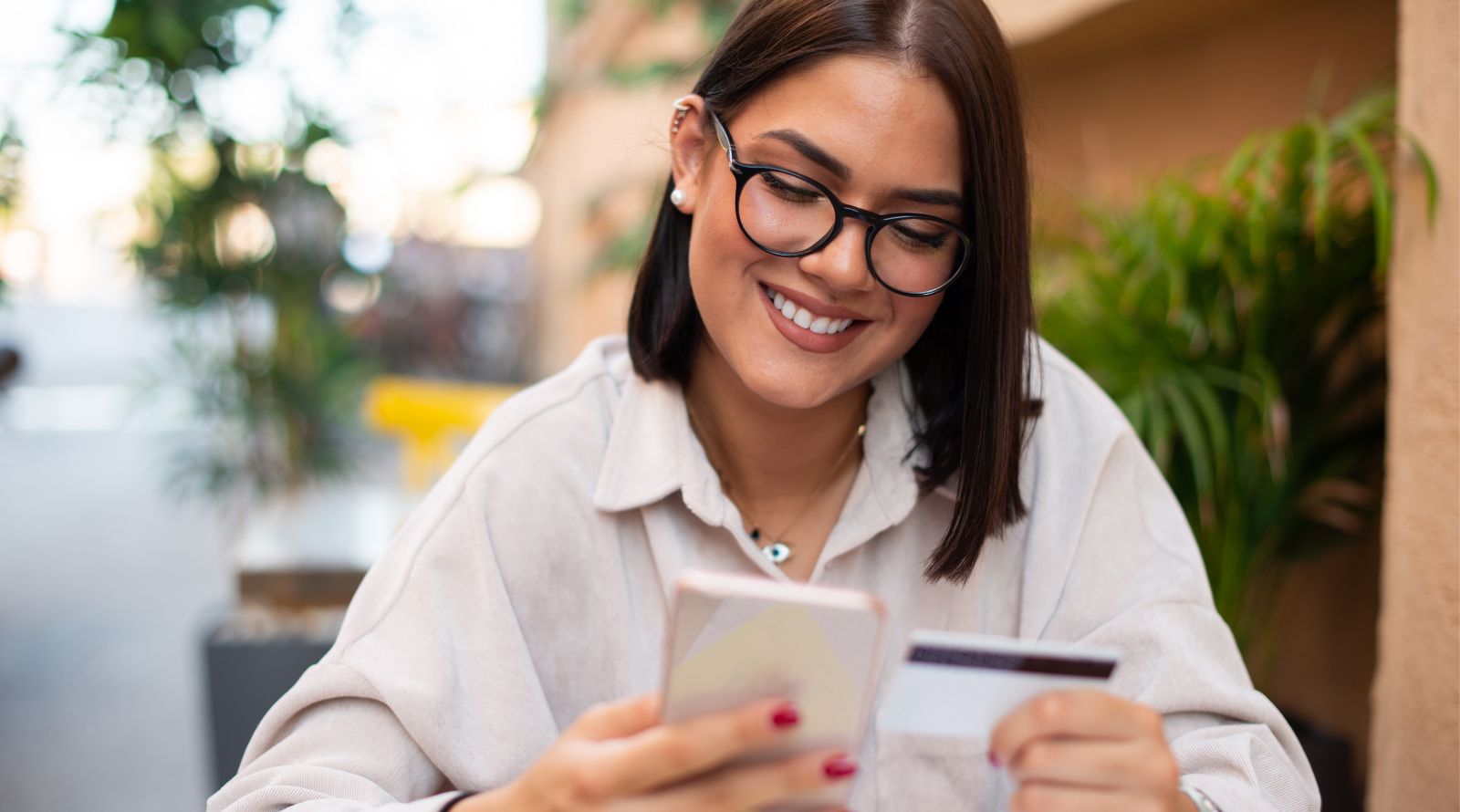 Girl on phone using debit card