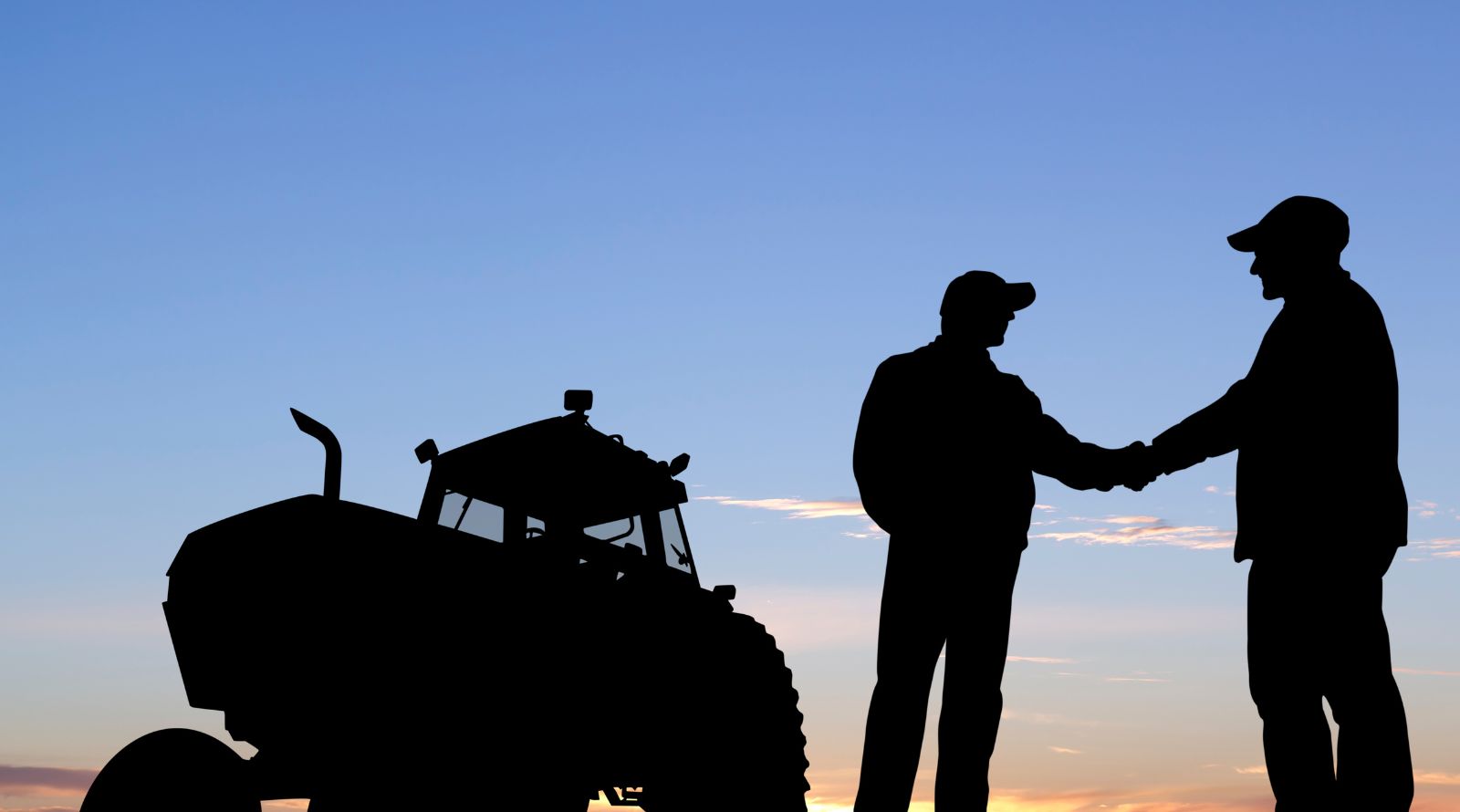 Shadow of two farmers and tractor